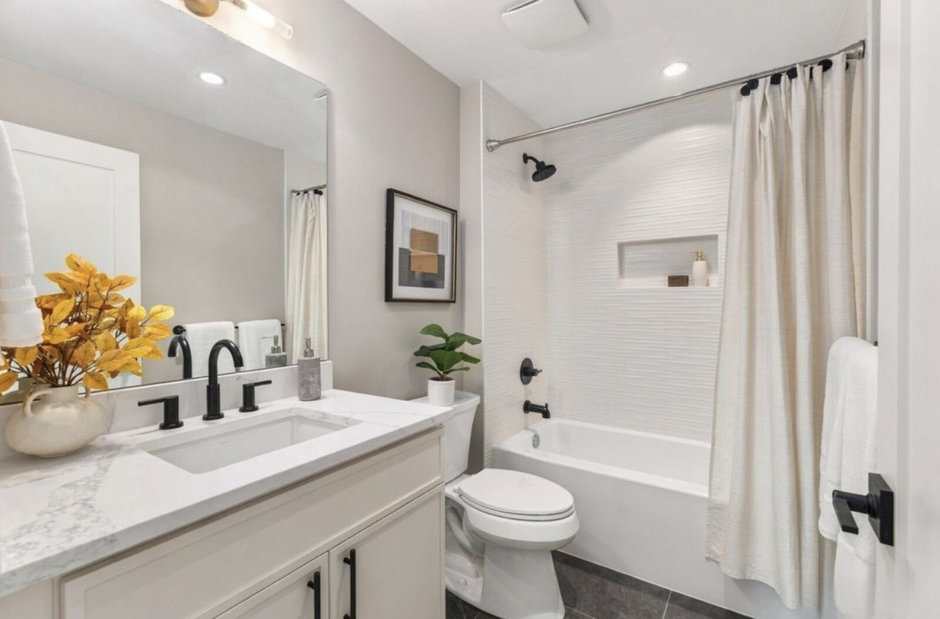 Tub and shower with white ribbed tile and recessed niche
