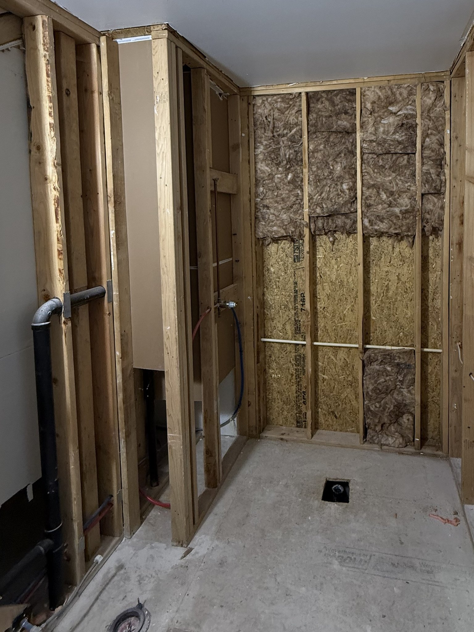 Before: the same bathroom stripped down to the studs