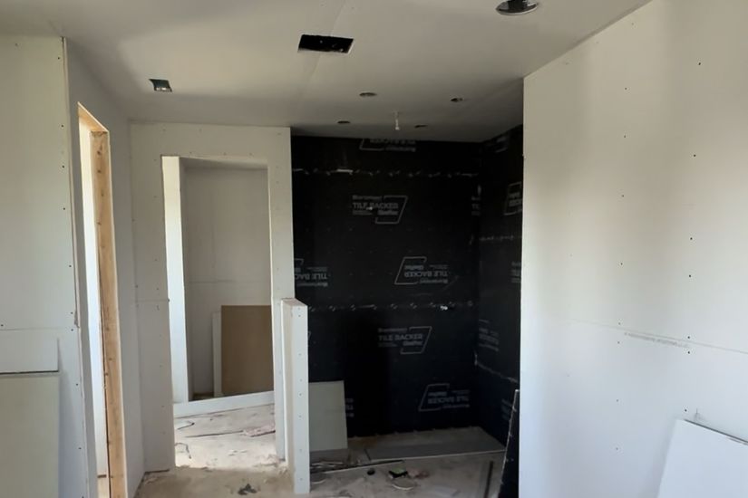 Before: the same bathroom with tile backer board installed before tiling