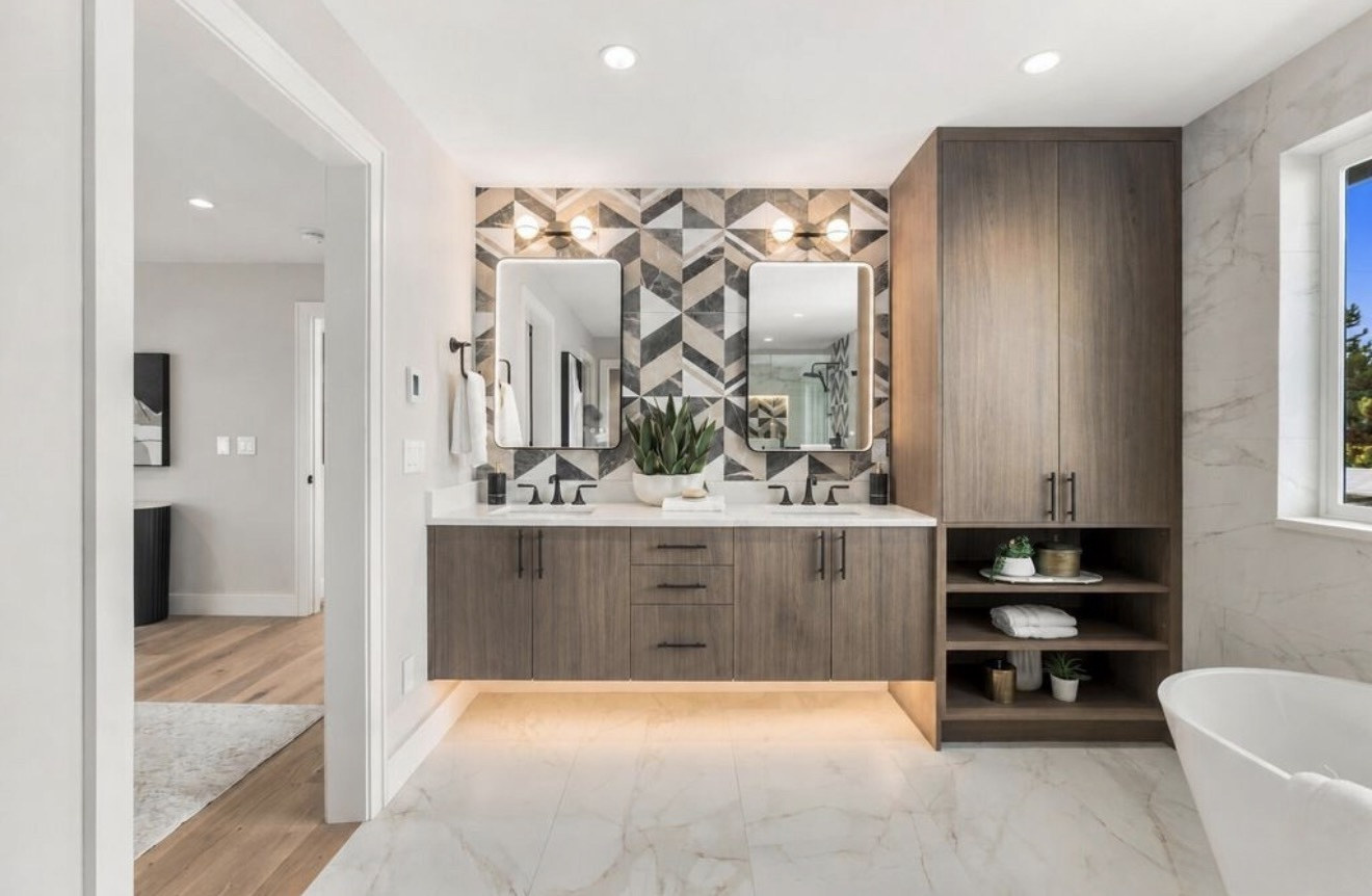 Double vanity with geometric chevron tile wall