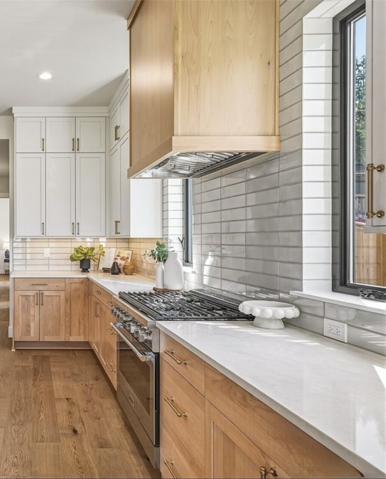 Remodeled kitchen with glossy gray tile backsplash and wood cabinets