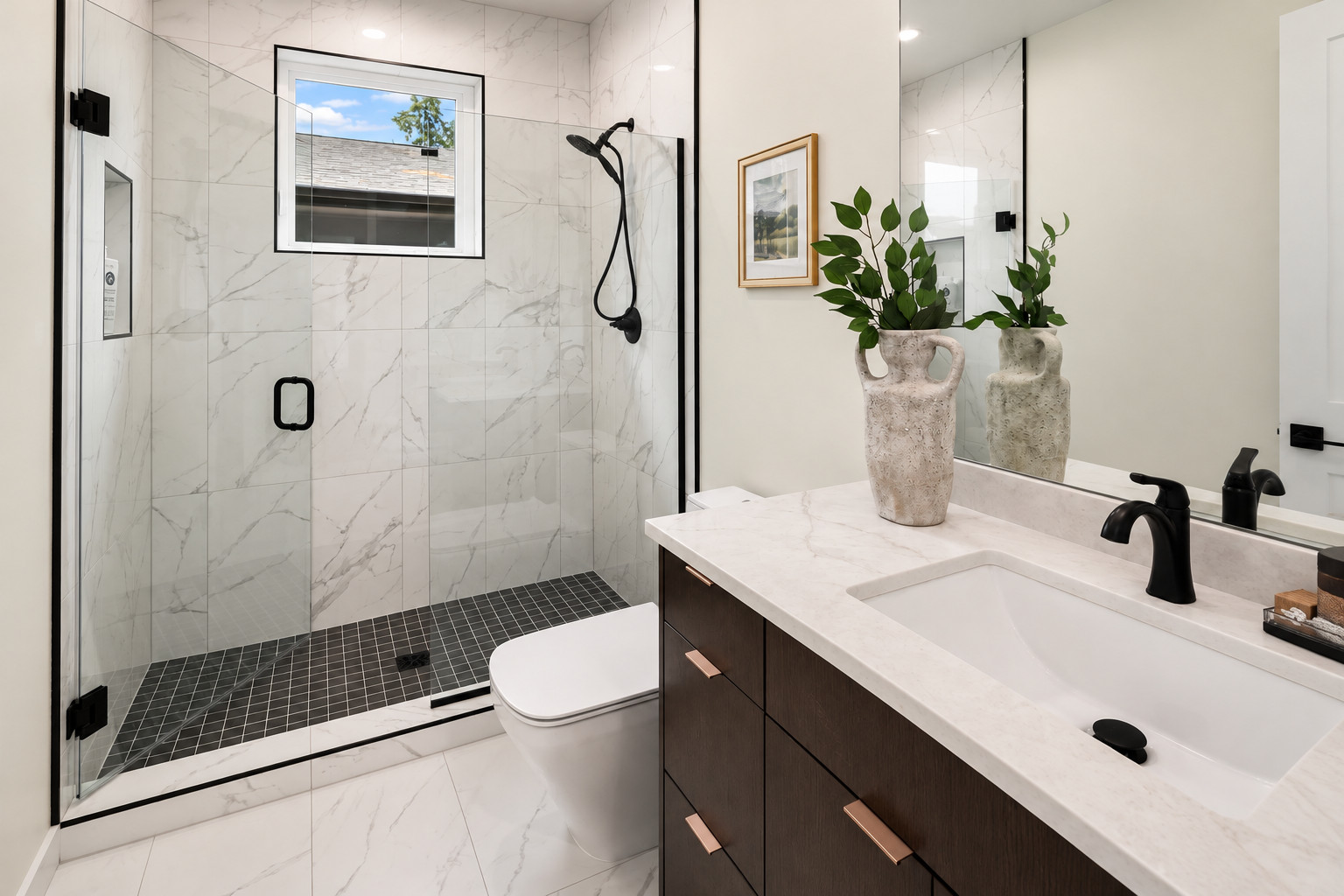 Custom tile shower with marble-look walls and black mosaic floor